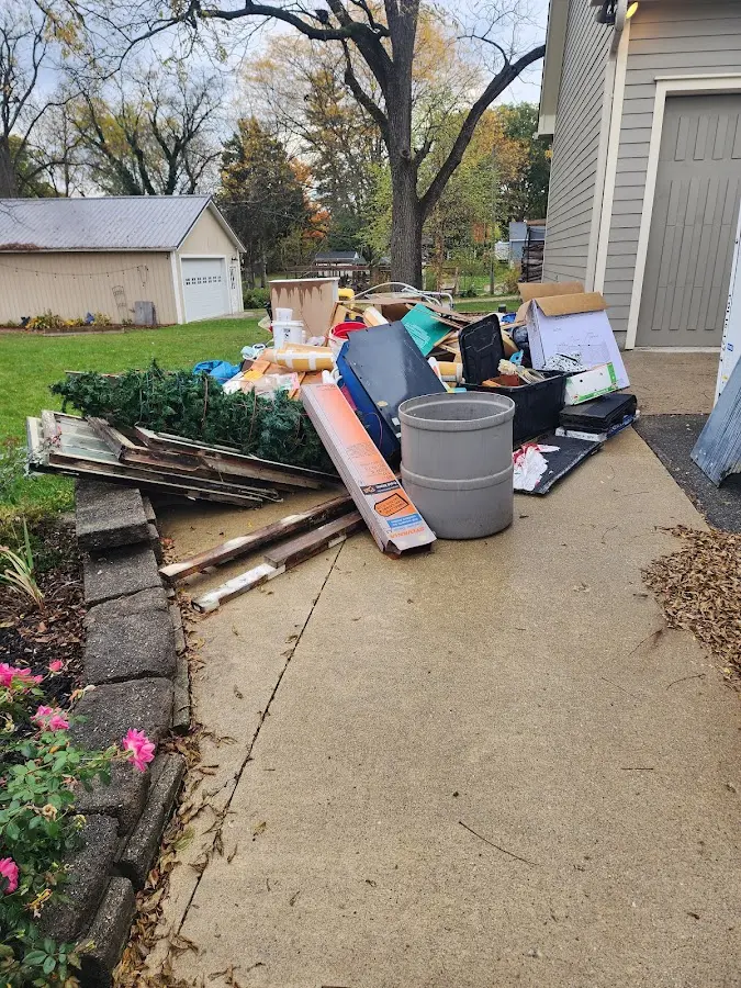 Dumpster being loaded with debris for 30 Yard Dumpster Rental in Morrisville
